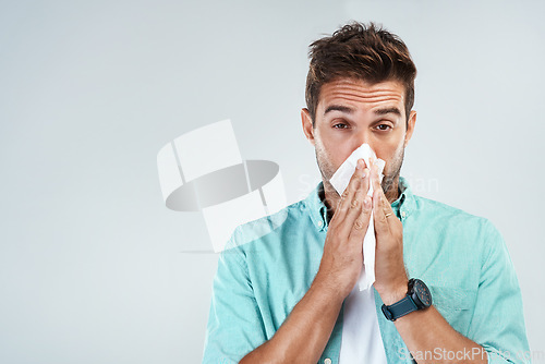 Image of Wipe nose, tissue and portrait of man in studio with flu allergy, sickness and virus on white background. Handkerchief, mockup space and face of male person for hayfever, cold and sneeze for sinus