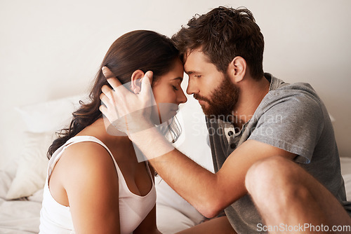 Image of Forehead, home bed and couple bonding, relax and enjoy morning together, quality time or sweet moment. Holiday, marriage or romantic people with love connection, affection and care in hotel bedroom