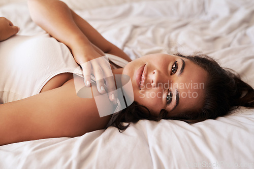 Image of Home portrait, bed and woman relax for morning wellness, weekend stress relief and peace in apartment. Hospitality, vacation holiday and face of person lazy, rest and cozy in Spain hotel bedroom