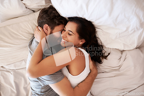 Image of Home bedroom, affection and happy couple hug, relax and enjoy relax morning together, bonding and smile. Happiness, intimate and top view of romantic woman, man or people embrace on hotel bed fabric