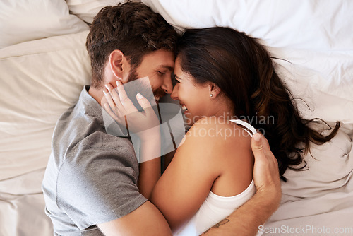 Image of Smile, bed and happy couple hug, relax and spending lazy morning together, bonding and intimacy on Spain vacation. Happiness, marriage and top view of romantic man, woman or people embrace in bedroom