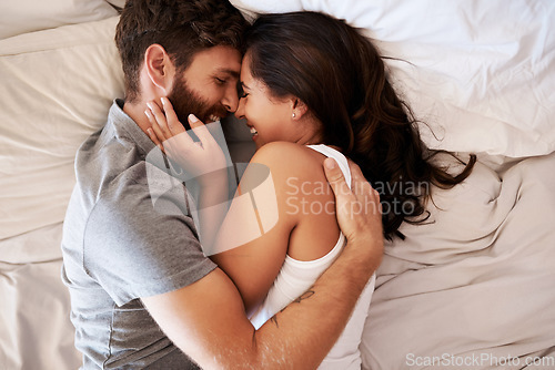 Image of Smile, bedroom hug and happy couple laughing at funny joke, relationship humour or home comedy in Spain. Marriage happiness, love bond and top view of relax man, woman or morning people laugh in bed