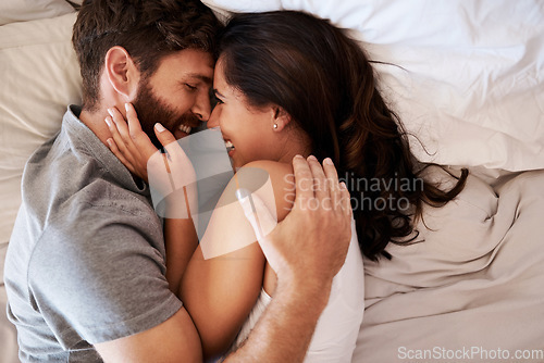 Image of Morning, bedroom hug and happy couple laugh at funny joke, relationship humor or comedy on honeymoon vacation. Affection, marriage and top view of relax man, woman or bonding people laughing in bed