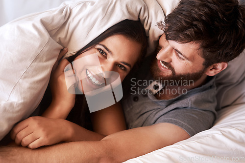 Image of Bed blanket, smile and portrait of happy couple, relax and enjoy morning together bonding on Ireland vacation holiday. Happiness, intimate and face of romantic woman, man or people in home bedroom