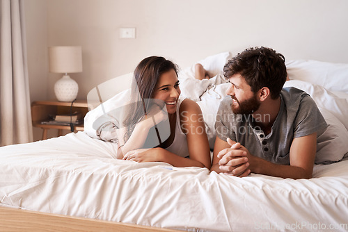 Image of Eye contact, home bedroom and happy couple relax, rest and enjoy quality time together on holiday, vacation or hotel bed. Wellness, love bond and morning man, woman or romantic people cozy in France