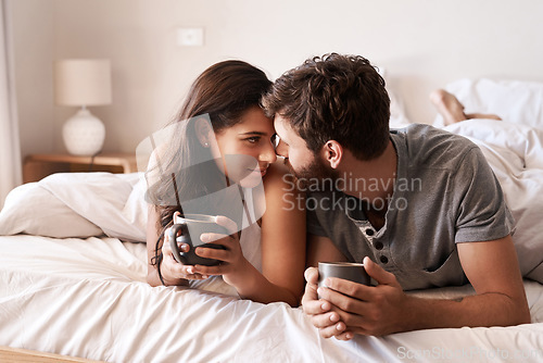 Image of Home bedroom, coffee and couple bonding, relax and enjoy morning latte, espresso or beverage drinks. Forehead, marriage or romantic man, woman or people with tea cup, love and affection in hotel bed