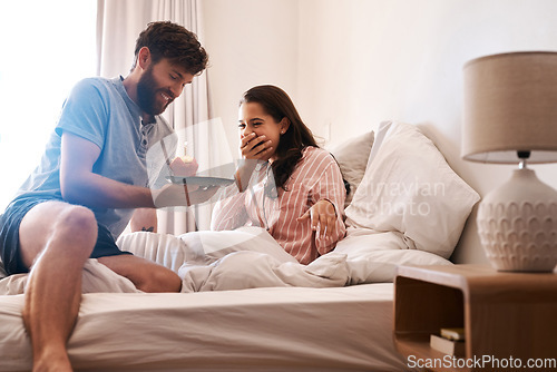 Image of Couple, bedroom and surprise birthday candle, cupcake or celebration dessert for excited woman shocked over food gift. Muffin, wow and people smile, happiness and celebrate special day on home bed