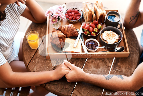 Image of Cafe food, breakfast and couple holding hands for support care, bonding or love on Valentines Day date. Morning, romantic people and brunch tray of croissant, strawberry or bread in coffee shop store