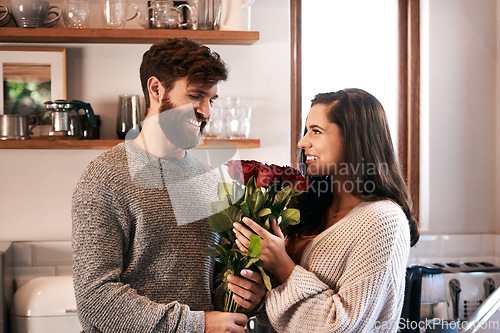 Image of Flowers, surprise gift and happy couple with roses, floral present or flower bouquet for Valentines Day in home kitchen. Wow, bonding and romantic man with love present, care and enjoy quality time