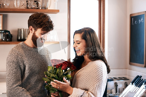 Image of Rose, surprise and happy couple with flowers, floral present or flower bouquet for Valentines Day in home kitchen. Birthday happiness, support and romantic man with love gift for marriage anniversary