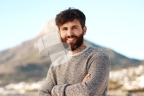 Image of Nature portrait, arms crossed and happy man relax with outdoor wellness, vacation freedom and smile for peace. Summer sunshine, mountain and male person on travel holiday in Cape Town, South Africa