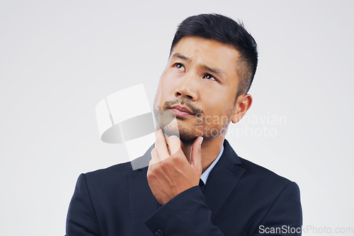 Image of Thinking, doubt and an Asian businessman with ideas isolated on a white background in a studio. Idea, space and a corporate employee with a choice, decision or planning a question on a backdrop