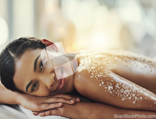 Image of Happy woman, portrait and relax at spa in salt scrub for body treatment, skincare or massage at resort. Calm female face lying on bed in relaxation with smile for exfoliation, zen or therapy at salon