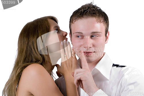 Image of The young woman whispers on an ear to the young man