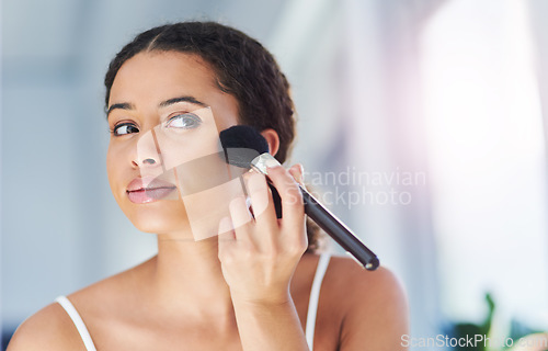 Image of Glamour, makeup and woman with a cosmetic brush for a natural, skin and face in her bathroom. Young, beauty and beautiful female person with cosmetics powder for a morning routine in her apartment.