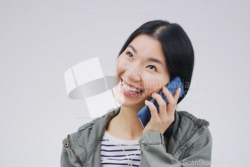 Image of Phone call, happy and Asian woman in studio smile for conversation, talking and chatting. Communication mockup, white background and female person on smartphone for network, contact and connection