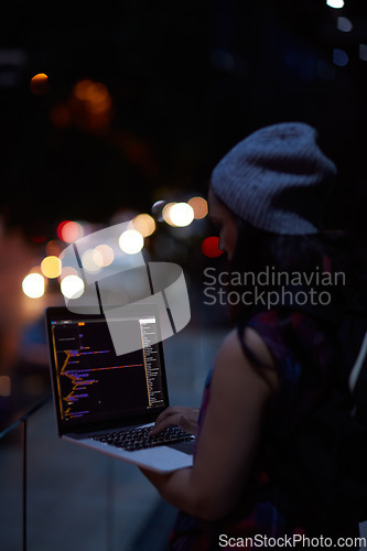 Image of Hacker, code and night with woman and laptop screen for ransomware, cyber security and phishing. Coding, technology and crime with programmer typing for fraud, network system and data scam