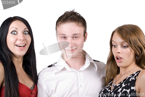 Image of young man and two surprised beauty young women