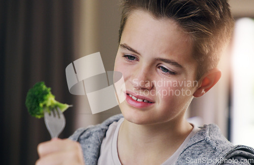 Image of Disgust, food and dislike with child and broccoli for nutrition, health and cooking. Sad, angry and dinner with boy and refuse to eat vegetable at home for eating problem, frustrated and fear