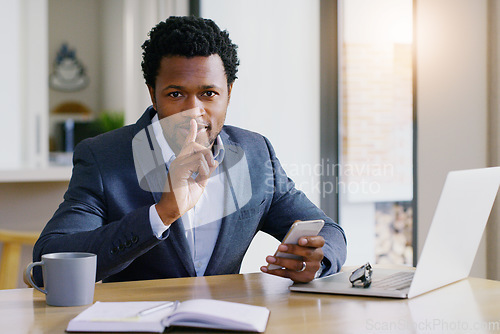 Image of Business, black man and secret portrait with phone and work from home with whisper. African male person, employee and laptop of a online finance worker hush gesture with confidential information