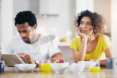 Image of Technology, breakfast and man ignore woman for social media, reading news and digital app in morning. Marriage, couple and sad female and male on tablet with relationship problem, ignoring and issues