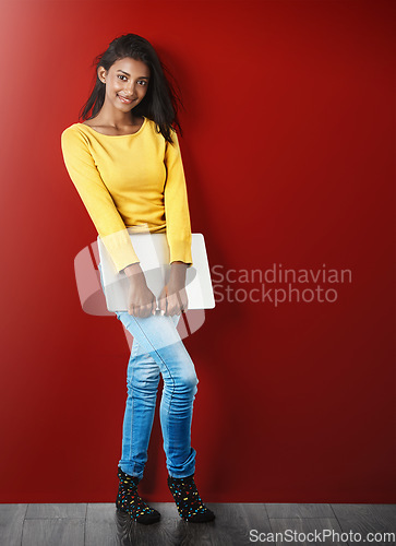 Image of Student woman, portrait and laptop by wall with smile for learning, education or research for development. Gen z gIrl, computer and happy for study, elearning and social network app by red background