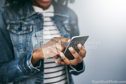 Image of Hands, phone and woman with chat by wall background for typing email, contact or texting on internet. Student girl, smartphone and web for blog, post or video on social network app for communication