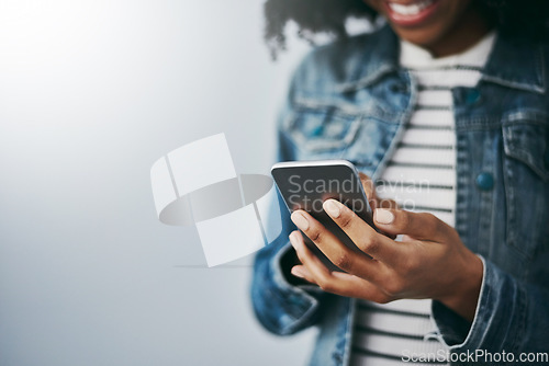 Image of Hands, cellphone and woman with typing by wall background with texting, mockup space or email on web. African girl, smartphone and chat for blog, post or video on social network app for connectivity