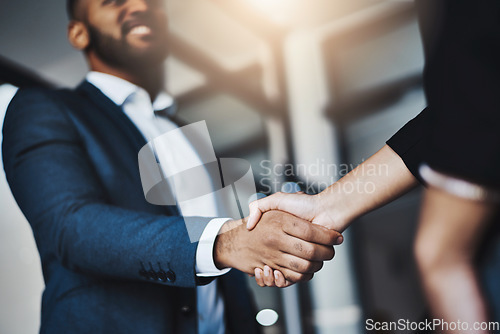 Image of Hand shake, man and woman with low angle in office for welcome, b2b agreement and onboarding with smile. Businessman, partnership and kindness in human resources, hiring or team building in workplace
