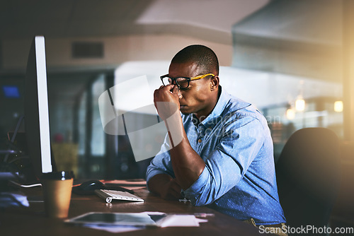Image of Black business man, stress and headache in night, office and fatigue by computer for project deadline. African businessman, burnout or anxiety in workplace by pc, web design startup and mental health