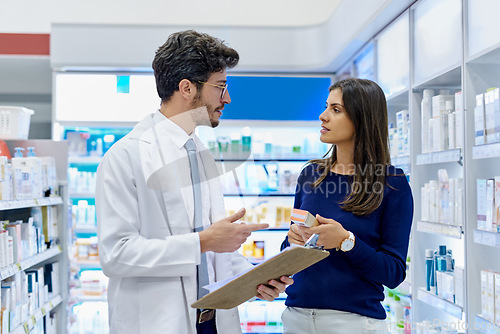 Image of Pharmacy, medicine and pharmacist talking to customer while working in a retail store. Professional man in pharmaceutical or medical industry for service, healthcare and advice for a woman client