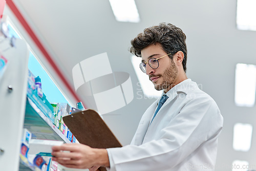Image of Pharmacist, clipboard and a man in pharmacy or working in a store for retail career. Male person in pharmaceutical or medical industry for service, healthcare and reading to check inventory on shelf