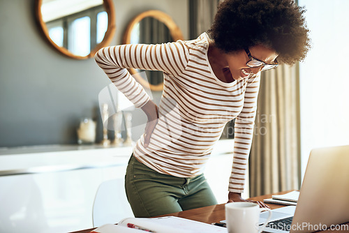 Image of Black woman, laptop and back pain in remote work from bad posture, stress or overworked strain at home. African female person or freelancer holding painful area in discomfort, spine or ache by desk