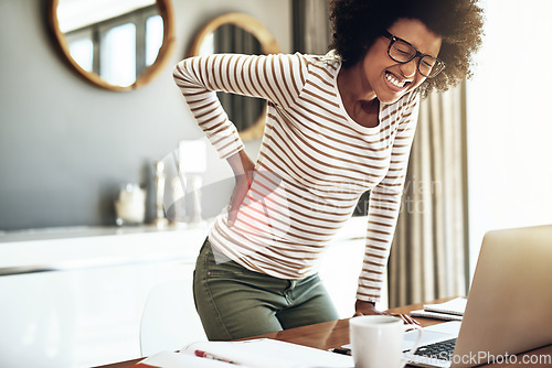 Image of Black woman, laptop and back pain injury in remote work, stress or bad posture from overworked strain at home. African female person or freelancer with painful backache, spine or discomfort by desk