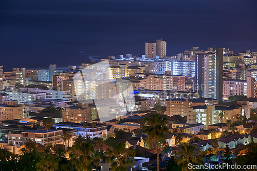 Image of City, buildings and urban landscape at night, skyline and location with architecture, landmark and travel. Cityscape, skyscraper and Cape Town view for tourism, traveling and background destination