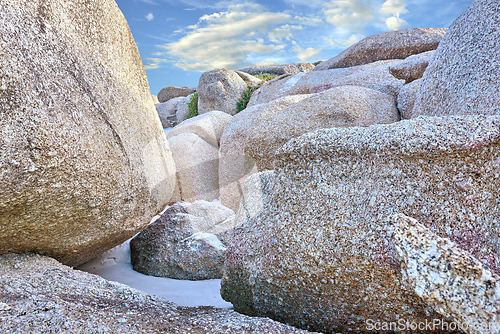 Image of Rocks, beach sand and landscape with travel and environment, holiday destination in South Africa with nature outdoor. Coastal location, natural scenery and fresh air, seascape and tropical adventure