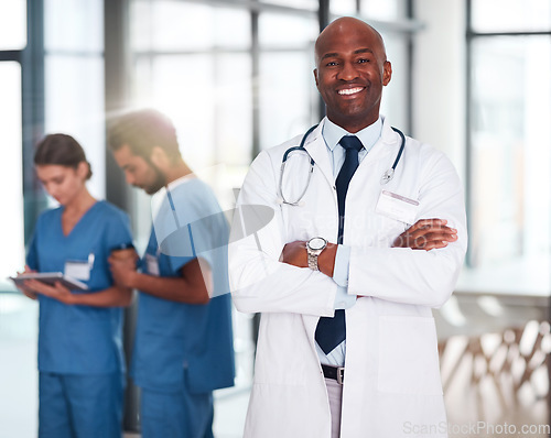 Image of Leader, doctor and portrait of person in hospital, healthcare or clinic with medical expert nurses to trust in quality care. Black man, medicine and happy brain surgeon, arms crossed and confidence