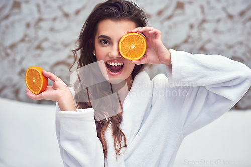 Image of Orange, beauty and hide with woman in hotel for breakfast, diet and relax. Nutrition, health and natural with female model and cover face with citrus fruit in bedroom for vitamin c, spa and facial