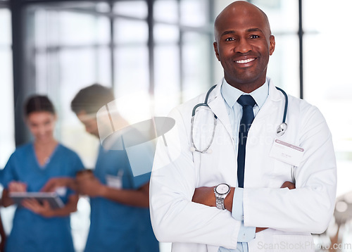 Image of Doctor, leader and portrait of man in hospital, healthcare and clinic for medical experience, expert trust and quality care. Black person, medicine and happy surgeon with arms crossed for confidence