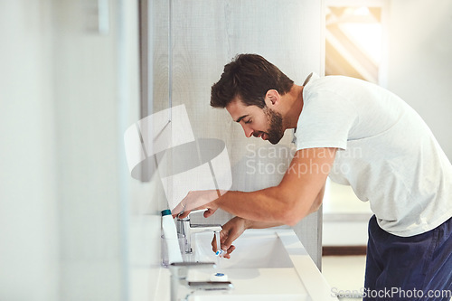 Image of Dental, morning and brushing teeth with man in bathroom for cleaning, shower and oral hygiene. Smile, cosmetics and health with male person and toothbrush at home for self care, breath and mouth