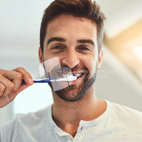 Image of Cleaning, portrait and brushing teeth with man in bathroom for dental, morning routine and oral hygiene. Smile, cosmetics and health with person and toothbrush at home for self care, breath and mouth