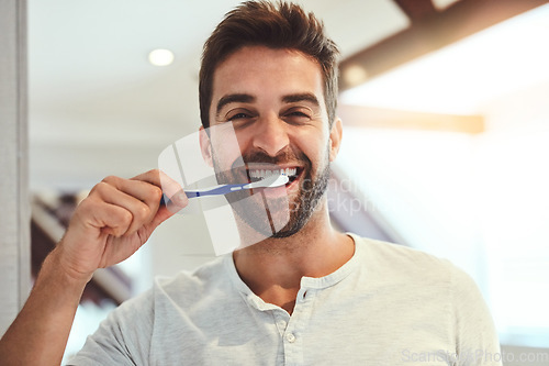 Image of Dental, portrait and brushing teeth with man in bathroom for cleaning, morning routine and oral hygiene. Smile, cosmetics and health with person and toothbrush at home for self care, breath and mouth