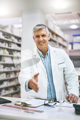 Image of Senior man, portrait and pharmacist handshake for greeting, introduction or hello in healthcare pharmacy. Happy elderly male person, medical professional or shaking hands for trust, welcome or advice