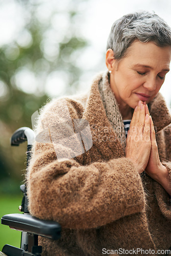 Image of Senior woman in wheelchair, prayer outdoor with worship and God with peace, religion with gratitude and faith. Spiritual female person with disability in nature, praying for guidance while in garden