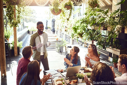 Image of Applause, restaurant and black man with business people in meeting for lunch discussion, planning and success. Cafe, teamwork and men and women clapping for winning, collaboration and achievement