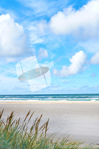 Image of Blue sky, beach and landscape, nature and travel with environment and coastal location in Denmark. Fresh air, tropical and land with seaside destination and ocean view, outdoor and natural scenery