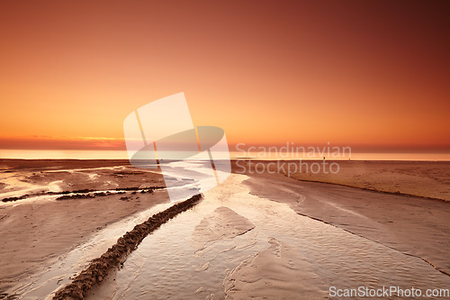 Image of Sunset sky, beach sand and landscape, nature and travel, environment and coastal location in Denmark. Mockup space, seaside destination and ocean view, outdoor and natural scenery with orange horizon