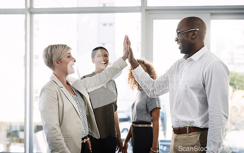 Image of High five, support and motivation with business people in office for success, winner and agreement. Partnership, goals and target with group of employees for teamwork, collaboration and solidarity