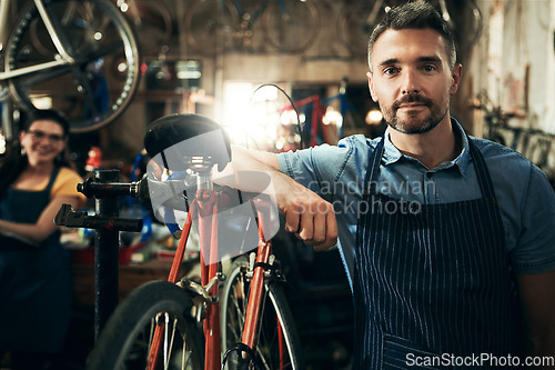 Image of Serious, portrait and technician man in bicycle shop working in store or cycling workshop for repair. Face, bike mechanic and confident male person, business owner or mature professional with pride