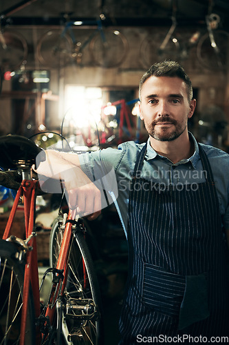 Image of Serious, portrait and repair man in bicycle shop working in store or cycling workshop. Face, bike mechanic and confident male person, business owner or mature professional technician from Australia.